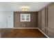 Dining room with custom trim on walls, hardwood floors, and modern light fixture at 1275 Calhoun Ave, Atlanta, GA 30344