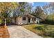 Exterior of well-kept home with a covered carport and landscaped lawn at 1275 Calhoun Ave, Atlanta, GA 30344