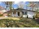 Charming home exterior featuring a carport, fresh paint, and a manicured lawn at 1275 Calhoun Ave, Atlanta, GA 30344