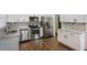 Bright kitchen with stainless appliances, white cabinets, and granite countertops at 1275 Calhoun Ave, Atlanta, GA 30344