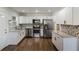 Beautiful kitchen with white cabinets, granite countertops, and stainless steel appliances at 1275 Calhoun Ave, Atlanta, GA 30344
