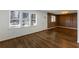 Open living room with hardwood floors and custom trim on the accent wall at 1275 Calhoun Ave, Atlanta, GA 30344