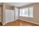 Bedroom featuring hardwood floors, a large window, and a spacious closet for ample storage at 1334 Jennie Sw Ln, Lilburn, GA 30047