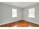 Cozy bedroom with hardwood floors and plenty of natural light from two windows at 1334 Jennie Sw Ln, Lilburn, GA 30047