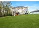 Exterior shot of backyard, deck, and lawn with lots of surrounding trees at 15 Glen Echo Dr, Covington, GA 30016