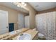 Bathroom featuring a shower with colorful polka dot curtain and single sink vanity at 15 Glen Echo Dr, Covington, GA 30016