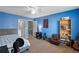 A blue painted bedroom with ceiling fan, bathroom access, skateboard, and bookcase at 15 Glen Echo Dr, Covington, GA 30016