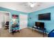bedroom with blue walls, ceiling fan, desk and TV set up at 15 Glen Echo Dr, Covington, GA 30016