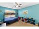 bedroom with blue walls, bunk bed and a window with natural light at 15 Glen Echo Dr, Covington, GA 30016