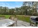 Backyard wooden deck with a grill, seating and beautiful landscape at 15 Glen Echo Dr, Covington, GA 30016