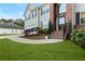 Close-up of a home's brick-accented entrance with a curved walkway and manicured landscaping at 15 Glen Echo Dr, Covington, GA 30016