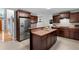Modern kitchen with a breakfast bar, stainless steel refrigerator, and ample cabinet space at 15 Glen Echo Dr, Covington, GA 30016