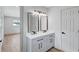 The bathroom has a gray vanity with double sinks, modern fixtures, and hardware at 3632 Glen Mora Drive, Decatur, GA 30032