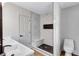 Bathroom with a double vanity, large walk-in shower with marble style tile, and black hardware at 3632 Glen Mora Drive, Decatur, GA 30032