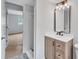 Modern bathroom featuring updated vanity, bronze fixtures, and shower, adjacent to the bedroom at 3632 Glen Mora Drive, Decatur, GA 30032
