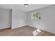 Bright bedroom featuring light hardwood floors, white trim, and a large window at 3632 Glen Mora Drive, Decatur, GA 30032