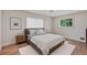 Bright bedroom features natural light from the window, a light fixture and light hardwood floors at 3632 Glen Mora Drive, Decatur, GA 30032