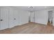 The bedroom has multiple doorways, light hardwood flooring, and neutral paint at 3632 Glen Mora Drive, Decatur, GA 30032