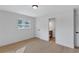 Bright bedroom with light-colored hardwood floors, white trim and walls, and a bathroom access door at 3632 Glen Mora Drive, Decatur, GA 30032