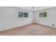 Bright bedroom featuring new floors, base molding and two windows at 3632 Glen Mora Drive, Decatur, GA 30032