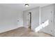 Bright bedroom featuring light hardwood floors, white trim, and access to a bathroom at 3632 Glen Mora Drive, Decatur, GA 30032