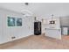 Open dining area and kitchen with black appliances, hardwood floors and modern lighting at 3632 Glen Mora Drive, Decatur, GA 30032