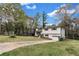 Split-level home featuring an attached garage, yellow door and a long driveway at 3632 Glen Mora Drive, Decatur, GA 30032
