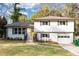 Charming split-level home featuring a bright yellow front door and a well-manicured lawn at 3632 Glen Mora Drive, Decatur, GA 30032