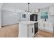 Modern kitchen featuring stainless steel appliances, center island and crisp white cabinets at 3632 Glen Mora Drive, Decatur, GA 30032