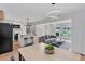 Open concept living and kitchen space with modern lighting, stainless appliances and hardwood floors at 3632 Glen Mora Drive, Decatur, GA 30032