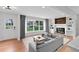 Bright living room featuring modern fireplace, wood accent wall, built-in shelves and gray sofa at 3632 Glen Mora Drive, Decatur, GA 30032