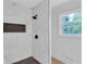 Modern bathroom features marble-style tile, black hardware, and a built-in shower niche at 3632 Glen Mora Drive, Decatur, GA 30032