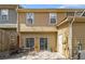 Backyard patio with table and chairs, sliders, and exterior home elevation at 2728 Keystone Gates Ct, Lithonia, GA 30058
