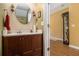 Bathroom with round mirror and updated vanity cabinet at 2728 Keystone Gates Ct, Lithonia, GA 30058
