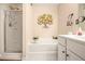 Bright bathroom features a walk-in shower, soaking tub with decorative fixtures, and a vanity sink at 2728 Keystone Gates Ct, Lithonia, GA 30058