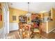 Bright dining area with a glass table, chandelier, and seamless access to the kitchen at 2728 Keystone Gates Ct, Lithonia, GA 30058