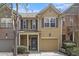 Charming two-story townhouse featuring neutral siding, black shutters, and a one-car garage at 2728 Keystone Gates Ct, Lithonia, GA 30058