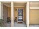 Inviting front porch with decorative chairs and plants, leading to a charming front door at 2728 Keystone Gates Ct, Lithonia, GA 30058