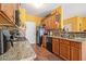 Charming kitchen featuring granite counters, tile floors, and black appliances at 2728 Keystone Gates Ct, Lithonia, GA 30058