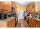 Well-equipped kitchen featuring granite countertops, wood cabinets, and modern appliances at 2728 Keystone Gates Ct, Lithonia, GA 30058
