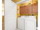 Laundry room featuring a washer, a dryer, upper cabinets and a door at 2728 Keystone Gates Ct, Lithonia, GA 30058