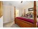 Main bedroom with four poster bed, ceiling fan, and adjoining bath at 2728 Keystone Gates Ct, Lithonia, GA 30058