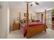 Main bedroom with four poster bed, ceiling fan, and neutral carpet at 2728 Keystone Gates Ct, Lithonia, GA 30058
