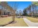 Exterior view of the Keystone Gates playground on a sunny day with mature trees at 2728 Keystone Gates Ct, Lithonia, GA 30058