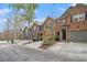 A row of townhouses featuring diverse exteriors and well-maintained front lawns, creating curb appeal at 2728 Keystone Gates Ct, Lithonia, GA 30058