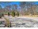 Street view into Keystone Gates with manicured trees, landscaping, and community signage at 2728 Keystone Gates Ct, Lithonia, GA 30058