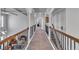 Upstairs hallway with decorative railing, arched doorways, and a view of the living space below at 3206 Letha Woods Drive, Conyers, GA 30094