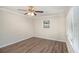 Bedroom with a ceiling fan, hardwood floors, and natural light at 6510 Hazel St, Lithia Springs, GA 30122