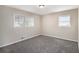 Bright bedroom with carpet, neutral walls, and natural light from two windows at 6510 Hazel St, Lithia Springs, GA 30122