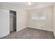 Cozy bedroom with neutral paint, carpet flooring, window with blinds and closet at 6510 Hazel St, Lithia Springs, GA 30122